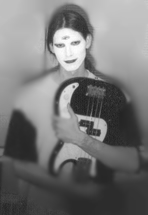 Michael Channing in makeup, in love with his bass and himself