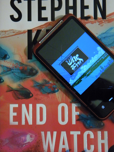 End of Watch by Stephen King with NES game on broken phone