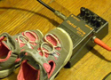 baby shoes and a stompbox